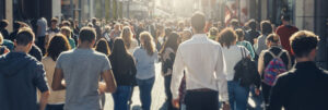 crowd of people walking through a shopping area